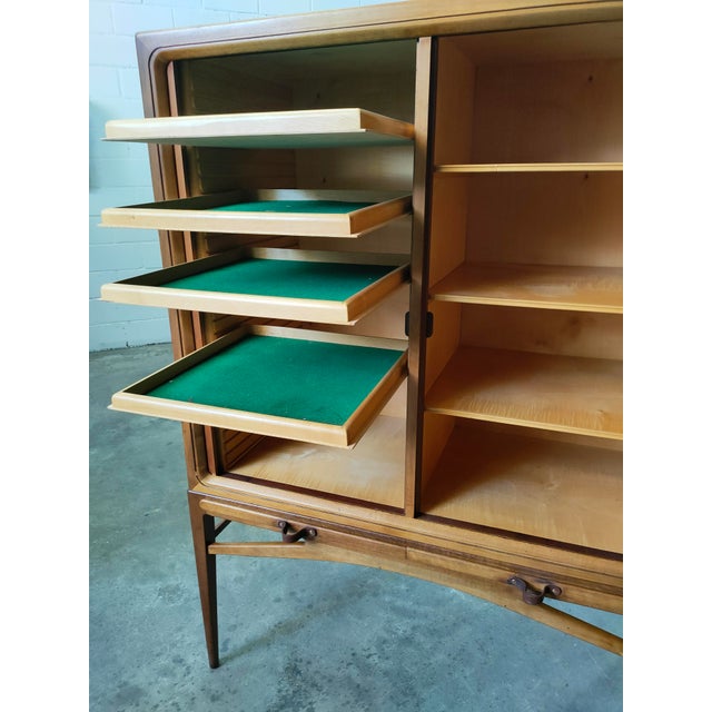 Sideboard made of teak wood, with two sliding doors, eight shelves, and two trays, Denmark, 1970s. Dimensions: Height...