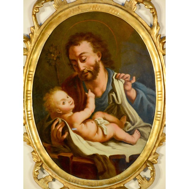 This painting is from Northern Spain of a religious reverse painting on glass depicting Saint Joseph with the Christ...
