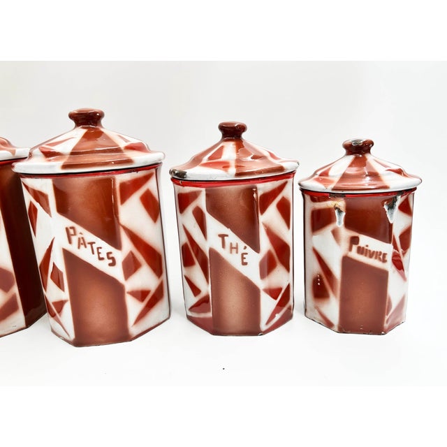 This beautiful and rare set of six antique french enamel kitchen canisters, manufactured by aubecq, showcases a striking...
