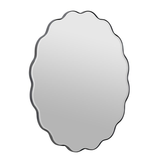 The round mirror, with its wavy frame, flows like a calming wave, bringing a touch of serenity and beauty to every glance.