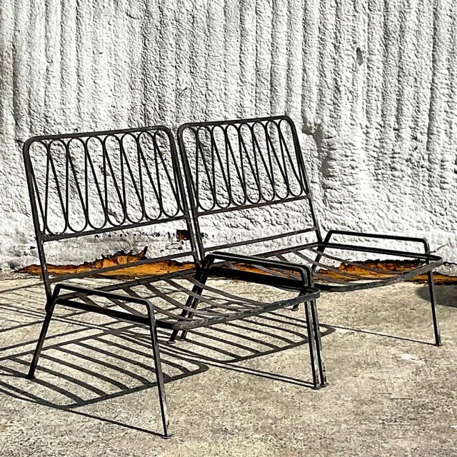 A fabulous pair of vintage MCM wrought iron slipper chairs. Made by the iconic Salterini group. Unmarked. The classic...