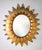 Stunning Spanish sunburst mirror in gilded metal with leaf motif lightning bolts, from the 1950s. It has an authentic aged...