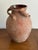 Hand-thrown antique terracotta storage jar featuring a classic rounded form with three sculptural pulled handles, an...