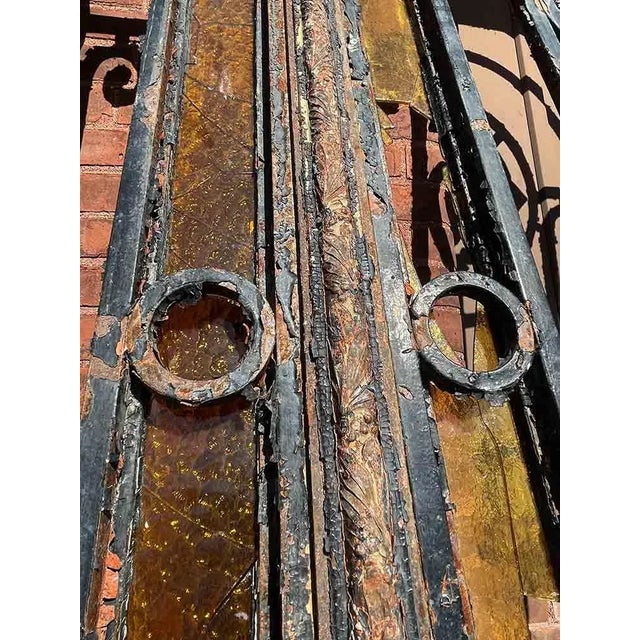 Antique late 19th century Italian Art Nouveau style wrought iron entry gates with arched transom. These elegant entry...