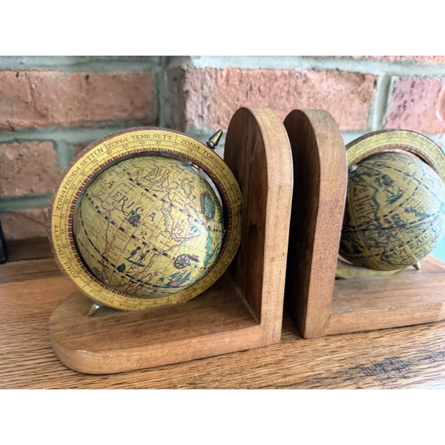 Great set of Old World Globe Bookends. Paper covered globes are mounted on wood. Made in Hong Kong. Each bookend is...