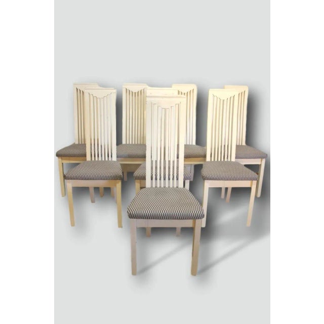 Series of eight white lacquered wood dining chairs in Mackintosh style. Some wear and tear on the lacquer due to the use...