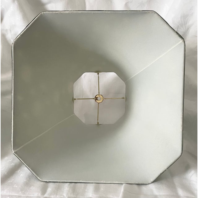 A charming French Country-style lampshade crafted from moss green fabric, beautifully printed with bees framed by crossed...