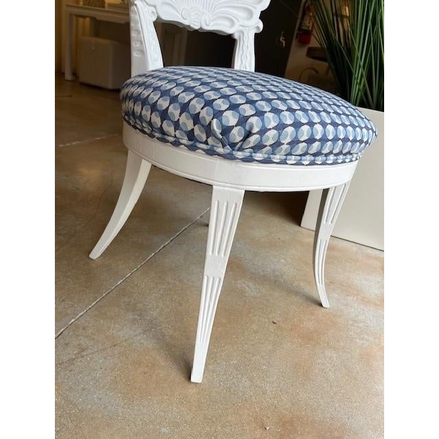 Sculpted shell back side chairs painted pristine white. Blue coin dotted linen Galbraith & Paul seat cover with a self...