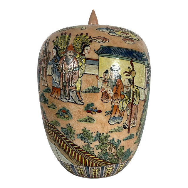 This unusual and older light peach coloured ginger jar is competently hand painted in rich enamels with an auspicious wrap...