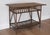 Charming mid century rattan table with a slatted apron and decorative bottom shelf with a downward bow. Rattan is...