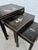 Set of three antique Chinese nesting tables, crafted in wood and finished in traditional black lacquer. Each tabletop is...