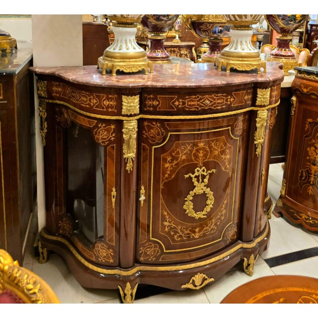 Introduce timeless grandeur into your home with this magnificent French Louis XVI display commode cabinet, masterfully...