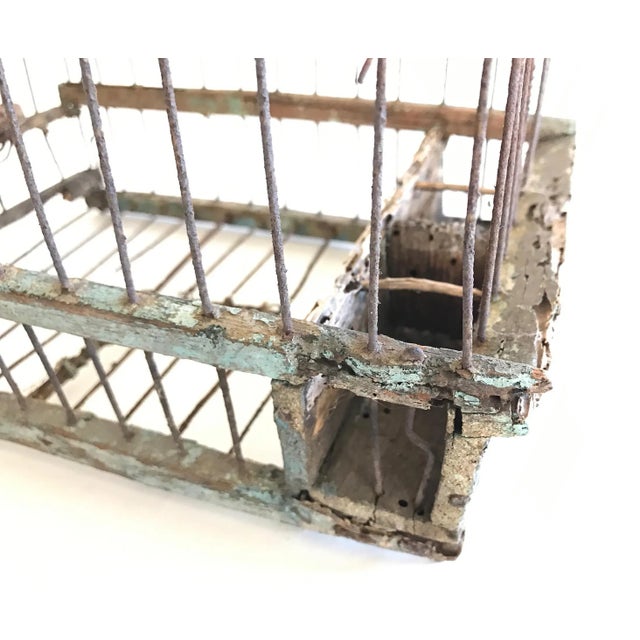 This is an antique wood and wire small animal cage. Significant wear on wood and metal. Beautiful green patina. Fantastic...