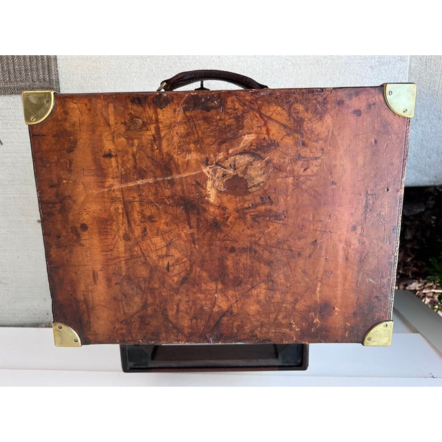Early 20th Century (1912-1940) English leather case was used to carry shotgun cartridges for hunting. It has been...