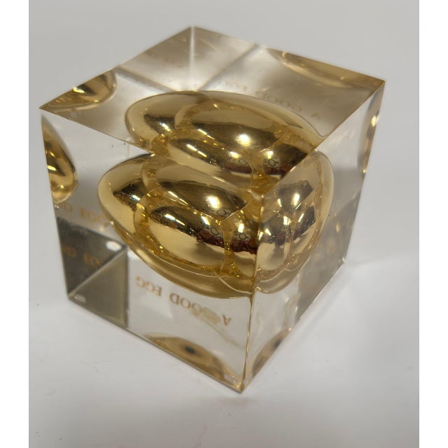 Postmodern Lucite “Golden Egg” Paperweight, “For a Good Egg,” circa 1970s A playful and iconic vintage paperweight,...