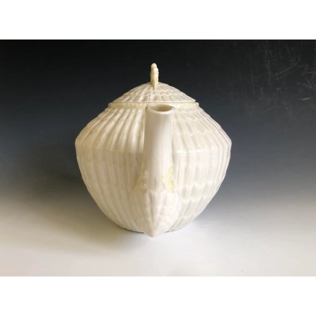 Beautiful Belleek pottery limpet yellow teapot & lid in a cream shell embossed background with yellow accent handle, spout...