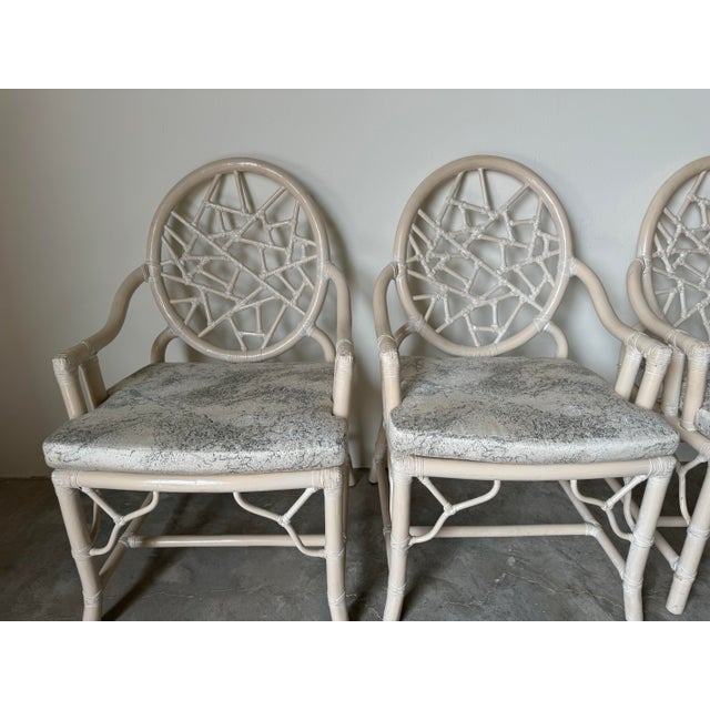 This is a magnificent set of four Vintage McGuire - style "Cracked Ice" rattan and leather dining chairs. The “Cracked...