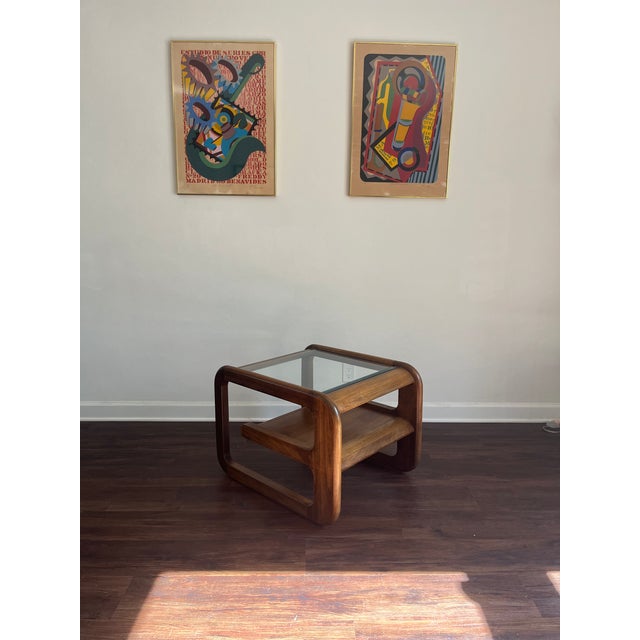 Stunning mid century modern coffee table featuring sculptural bentwood walnut design with inset glass top and lower...