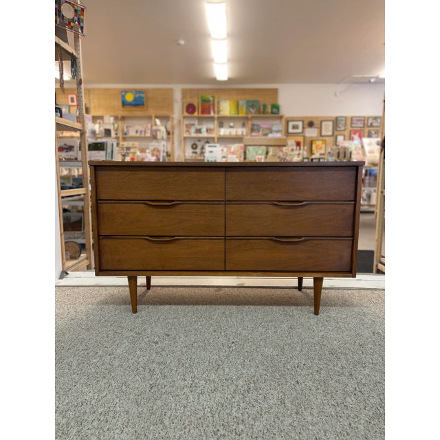 Walnut Toned 6 Drawer Low Dresser. Tapered Legs and Carved Wood Handles , Consistent with the Era it Was Made. Dovetail...