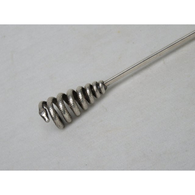 Elegant letter opener with a ''snake'' as a handle, silver plated. The scale structure of the beating and the head were...