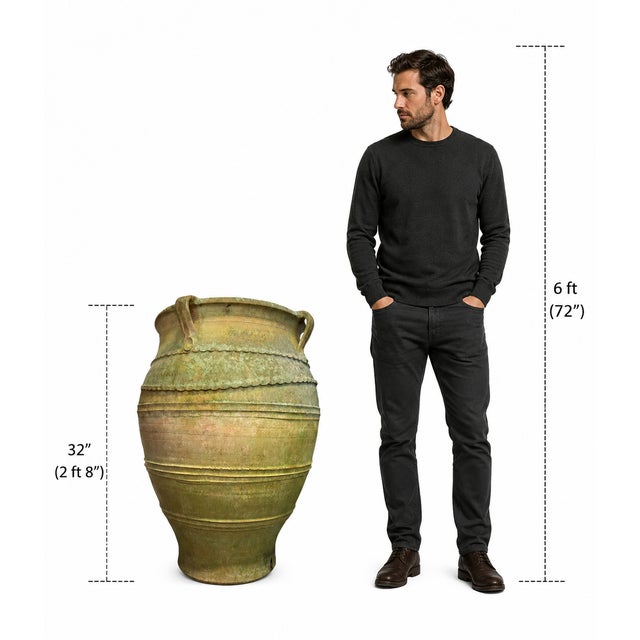 A striking late 19th-century Greek terracotta olive jar, dating to circa 1890, featuring beautifully preserved hand-...