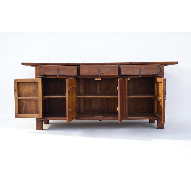 This 19th century sideboard was handmade from sturdy elm. Features a 3 door opening and 2 inner long shelves for simple,...