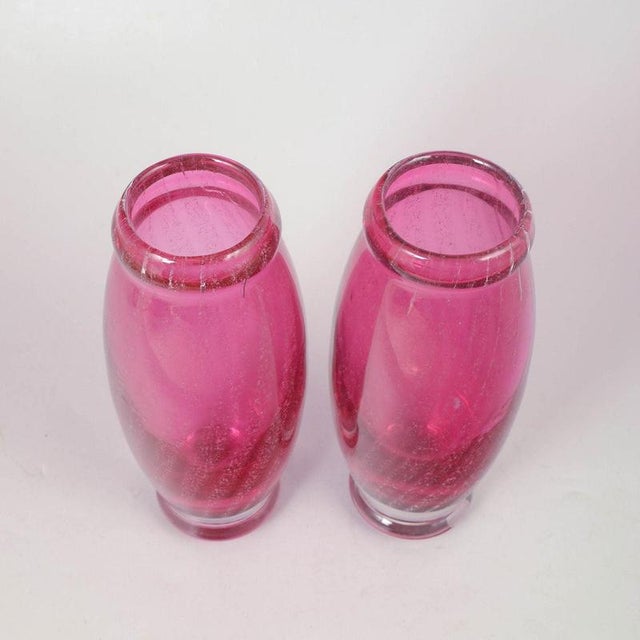 Pair of Chribska glass vases. Elegant set of two hand-blown pink art glass vases with baluster form, clear base and signed...