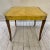Italian yellow leather wrapped dining table with wooden legs. This petite table comes with 1 leaf and measures 51.5“ long...