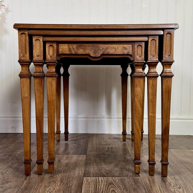 This set of three nesting tables is from the Vercelli Collection by Drexel. Features four-way book-matched walnut veneer...