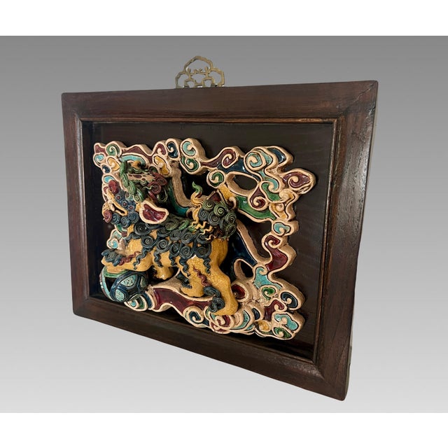 Magnificent Shiwan Chinese tile mounted on an expensive custom two tone wood frame with Chinese style brass hanger. Foo...