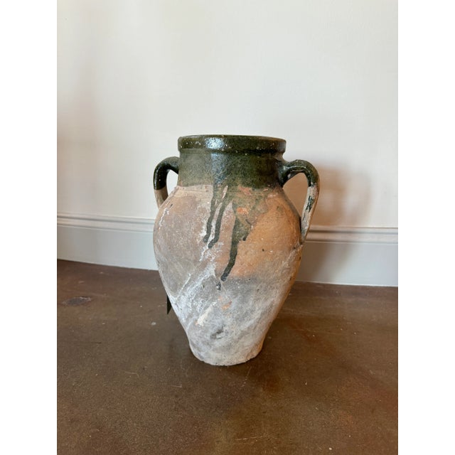 Handcrafted French olive jar with medium olive green glass inside and on top. Exposed clay has acquired a soft patina.