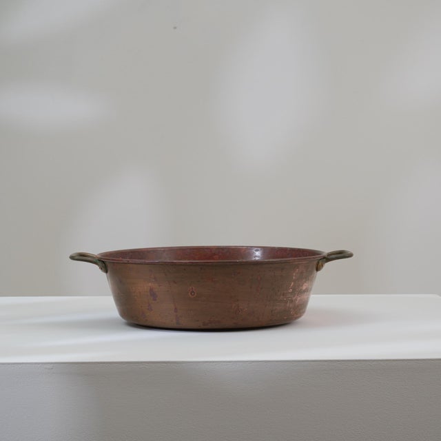 This 19th Century Belgian copper pot presents a warm, timeworn character that reflects its utilitarian origins and...