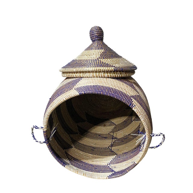This traditionally-crafted basket with lid originates in Senegal, West Africa. The Wolof women in rural regions handweave...