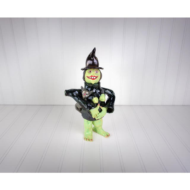 One of ten in a collection of sculptural postmodern pottery teapots, each with a feminist witch design. They come from a...