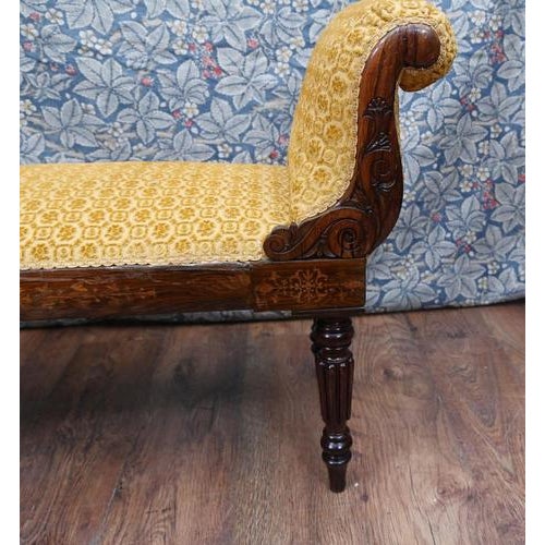 A handsome Regency mahogany window seat or stool, dating to around 1820. The bench features elegant scrolling end supports...