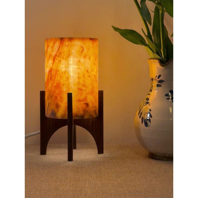 Comet pairs a hand-carved Egyptian alabaster shade with a geometric walnut base, combining contemporary form with...