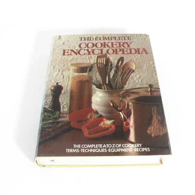 Vintage hardcover British cookbook. This has a beautiful cream linen cover with gold illustration on the front and gold...