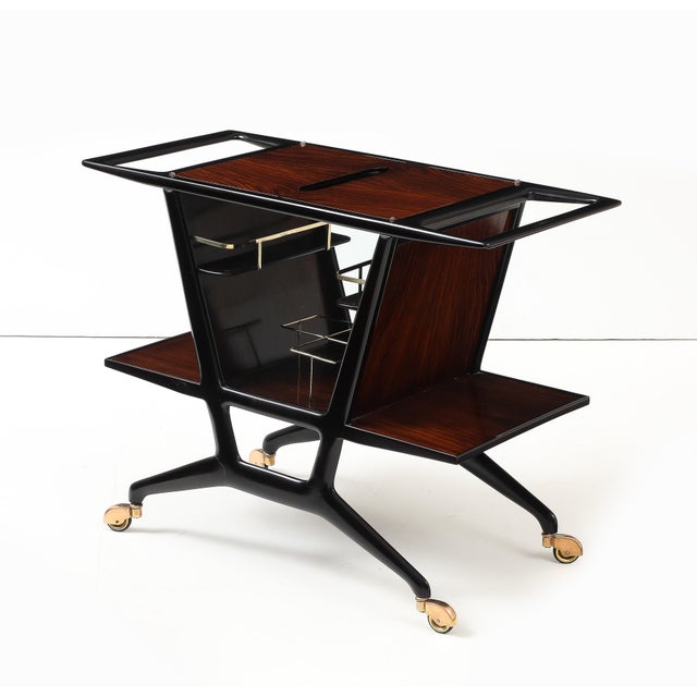 Beautiful 1950's modernist ebonized wood and rosewood with enclosed bottle holder bar cart designed by Cesare Lacca, fully...