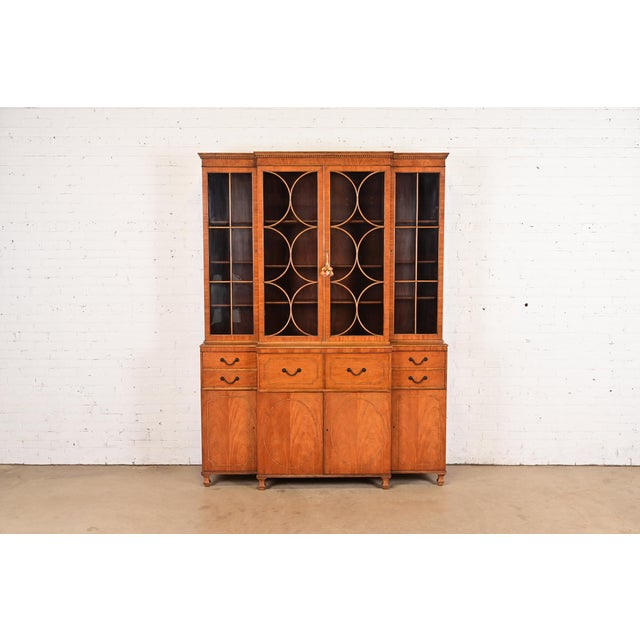 A gorgeous Georgian or Chippendale style breakfront bookcase cabinet with drop front secretary desk By Baker Furniture...