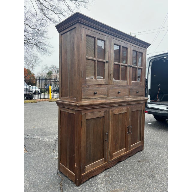 Beautifully crafted wood cabinet hutch made circa 2010s in the Rustic Farmhouse / Transitional style, featuring three...