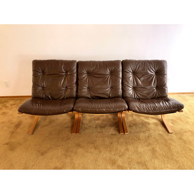 Three authentic Ingmar Relling Siesta low back lounge chairs with leather cushions and teak frames. The chair frames,...