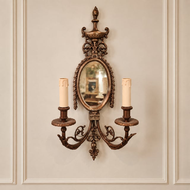 Add distinctive European character to your interior with this ornate bronze two-light wall sconce featuring an integrated...