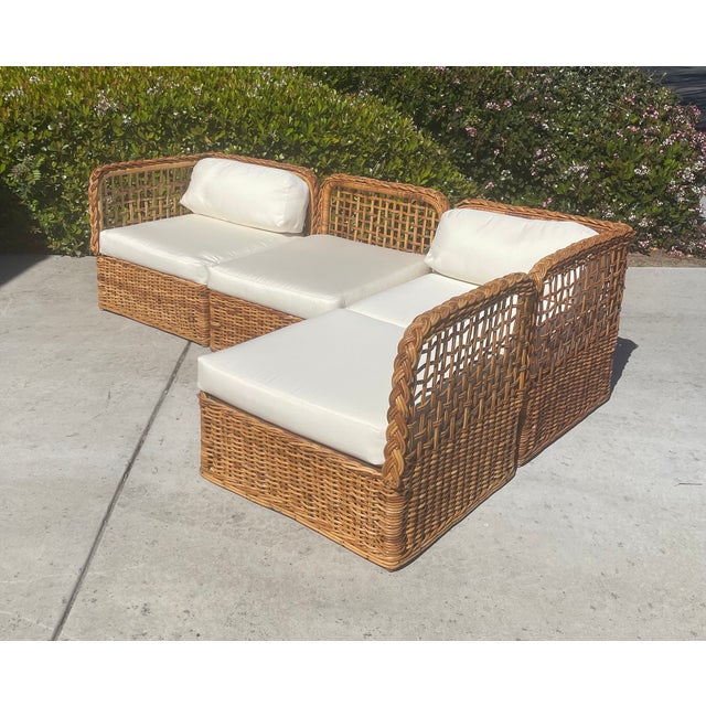A stunning four-piece wicker sectional sofa featuring substantial handwoven construction and distinctive braided trim...