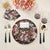 Add an elegant decorative element to any table with our Festoon Flowers Vegan Leather Round Pebble Placemat, inspired by...