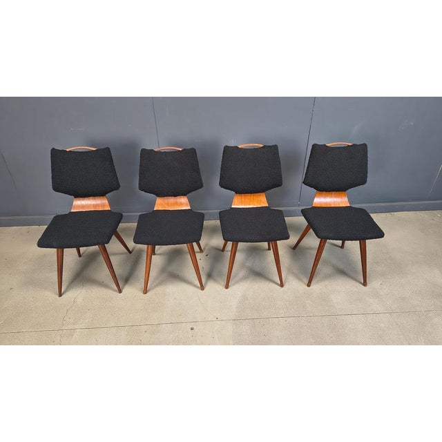 Beautiful dining chairs with elegant plywood frames and reupholstered cushions in black boucle. The chairs also have a...