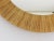 A beautiful round modernist wall mirror with a bast / raphia frame from the 1950s, made in France. In excellent condition.