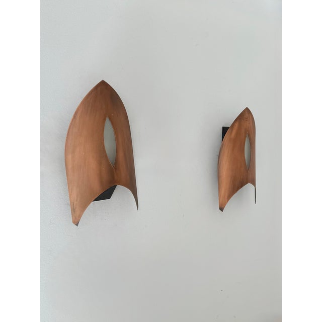 Pair of wall sconces with a copper frame and a frosted glass diffuser, made in France in the 1970s. Original design,...