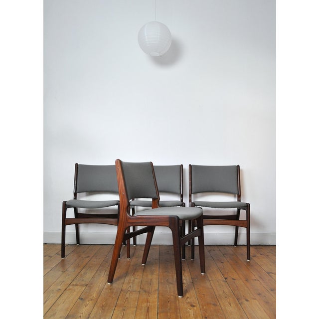 Set of four dining chairs designed by Erik Buch for Oddense Maskinsnedkeri. Solid teak frames with new fabric upholstered...