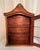 Vintage wall display cabinet has scroll and shell cornice, glass front and side panes, and gold metal knob. Original latch...