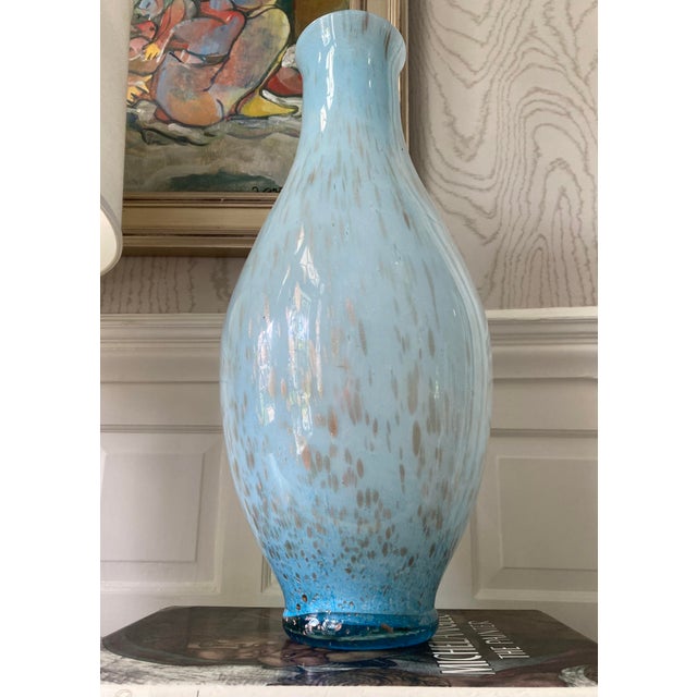 Suspended gold and silver flecks catch the light in this tall 1970s Italian Murano-style handblown blue teardrop art glass...